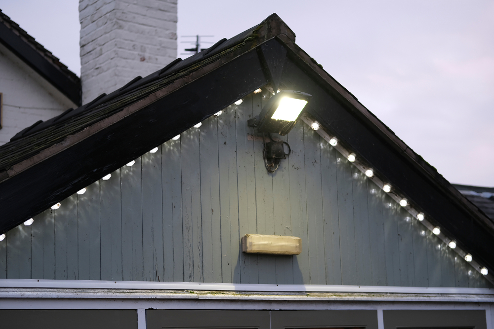 A house's exterior with a spotlight.