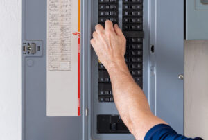 Electrician working on electrical panel